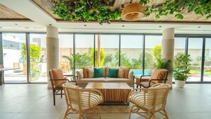 A spacious indoor area with a large sofa set, wicker chairs, and a coffee table. - Twin room in Private villa (Dubai)