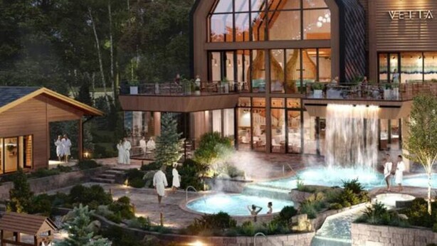 A modern hotel with a large glass facade, outdoor pools, and a waterfall feature. - Beautiful Jacuzzi Suite with Garden View/Studio (Shanty Bay)