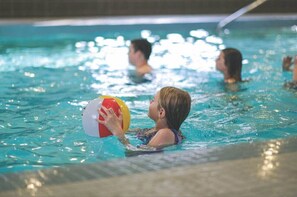 A swimming pool with people in the water.
