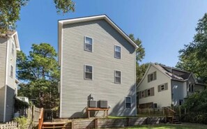 A two-story residential building with a gabled roof and a front porch. - Colington Harbour OBX Cottage (Kill Devil Hills)