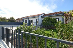 Stunning garden views surround this property, featuring a well-maintained garden with shrubs and a small tree.