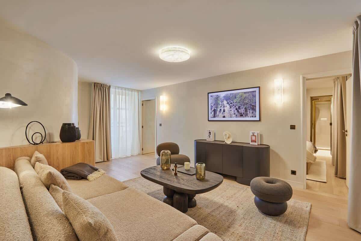 A modern living room with a sofa, a coffee table, and a sideboard.