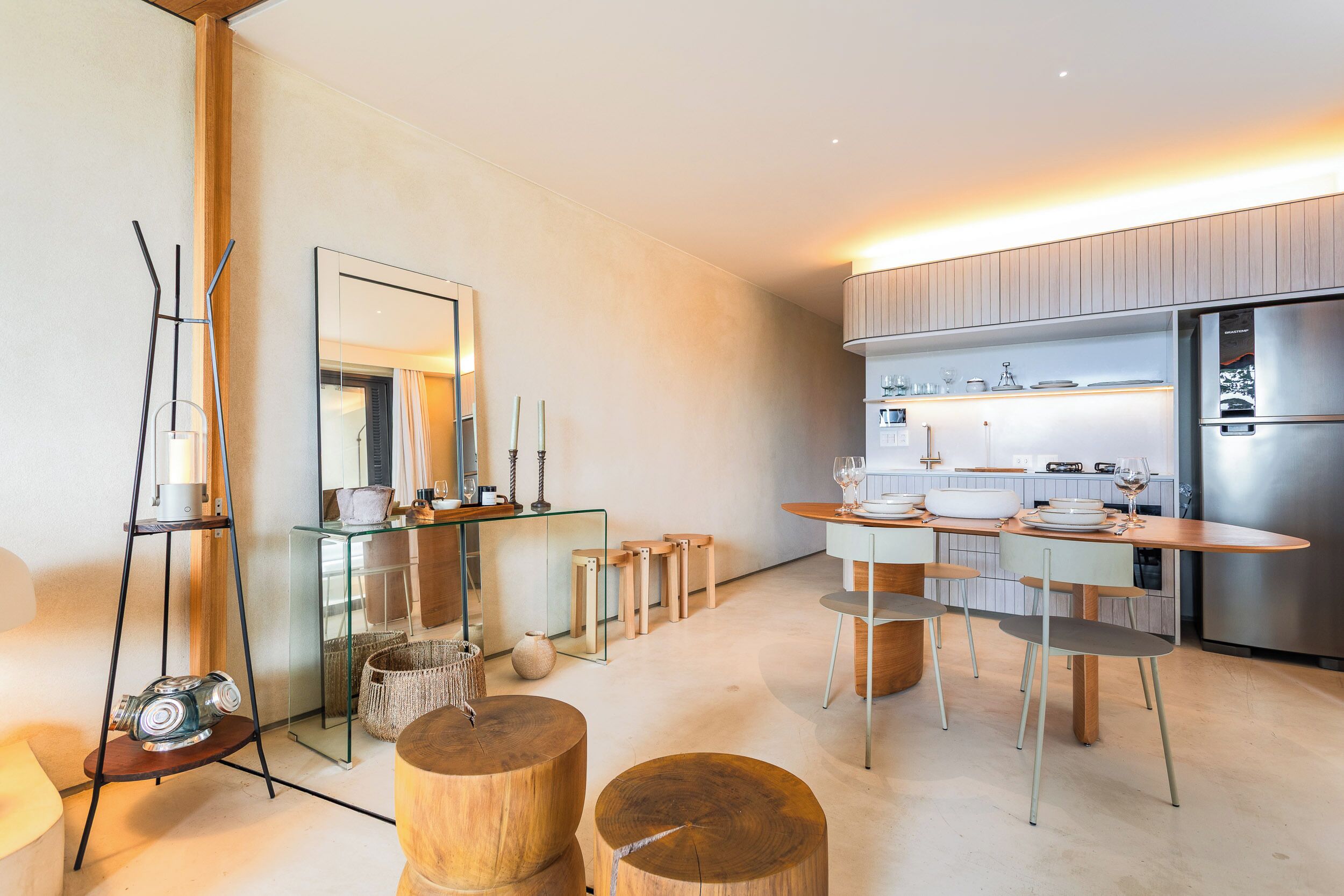 A modern kitchen with a dining area, featuring a large island, stainless steel appliances, and contemporary furniture.
