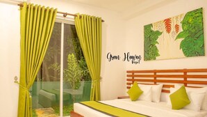 A bedroom with a bed, green curtains, a glass door, and a painting on the wall.