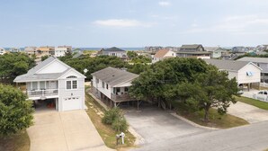 A residential area with houses, a driveway, and a clear sky.