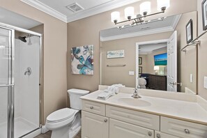 A bathroom with a shower, toilet, sink, and vanity. - Amalfi Coast 209A - Gulf View, Swimming Pool, Tennis Court, Near Shops + Dining! (Miramar Beach)