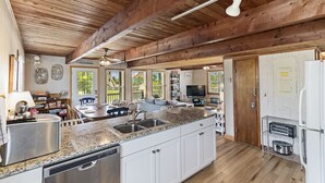 A spacious kitchen with granite countertops, white cabinetry, and a wooden ceiling. - Semi oceanfront home in Salvo w/ beach access just across the street! (Salvo)