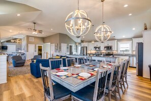 Enjoy cooking and dining in this well-equipped kitchen with a central island, sink, and ample counter space.