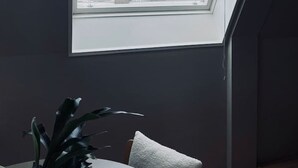 A room with a skylight overlooking a cityscape, including a tall tower structure. - Main Street Beach apartment 150 meters from the beach  (Noordwijk)