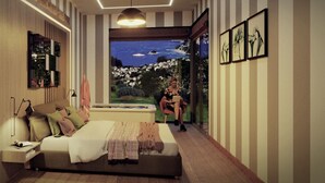 Een slaapkamer met een groot bed, een nachtkastje, een leeslamp, een raam met uitzicht op een landschap en kunstwerken in een lijst aan de muur.