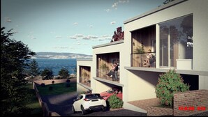 Een modern huis met twee verdiepingen, met een auto op de oprit, een balkon met een hekwerk en uitzicht op de zee.