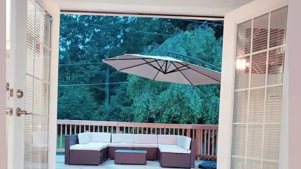 An open patio with a sectional sofa and an umbrella. - Pocono Mountains, Hidden-Gem GameRoom, Firepit, Min to all Attractions (Cresco)