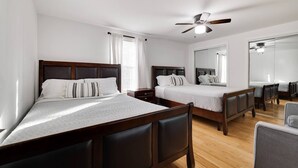 A hotel room with two beds, a ceiling fan, a large mirror, and a wooden floor. - Pocono Mountains, Hidden-Gem GameRoom, Firepit, Min to all Attractions (Cresco)