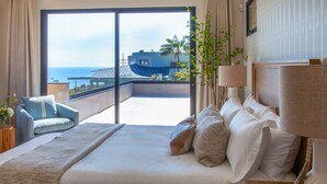 A bedroom with a large bed, a view of the ocean, a balcony, and a plant. - Goldenview | 4BR Ocean, City & Bay Escape + Spa (San Diego)