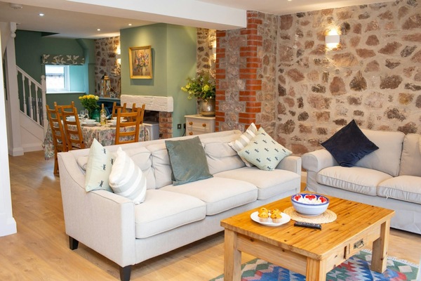 Large sofa and coffee table with dining area behind