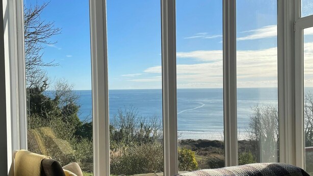 A room with large windows offering a view of the sea and surrounding landscape. - Stella Maris, Freshwater East (Freshwater East)