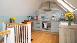 A kitchen with a modern design, a microwave, a kettle, and a toaster on the counter. - Vilureef, Broad Haven (Broad Haven)