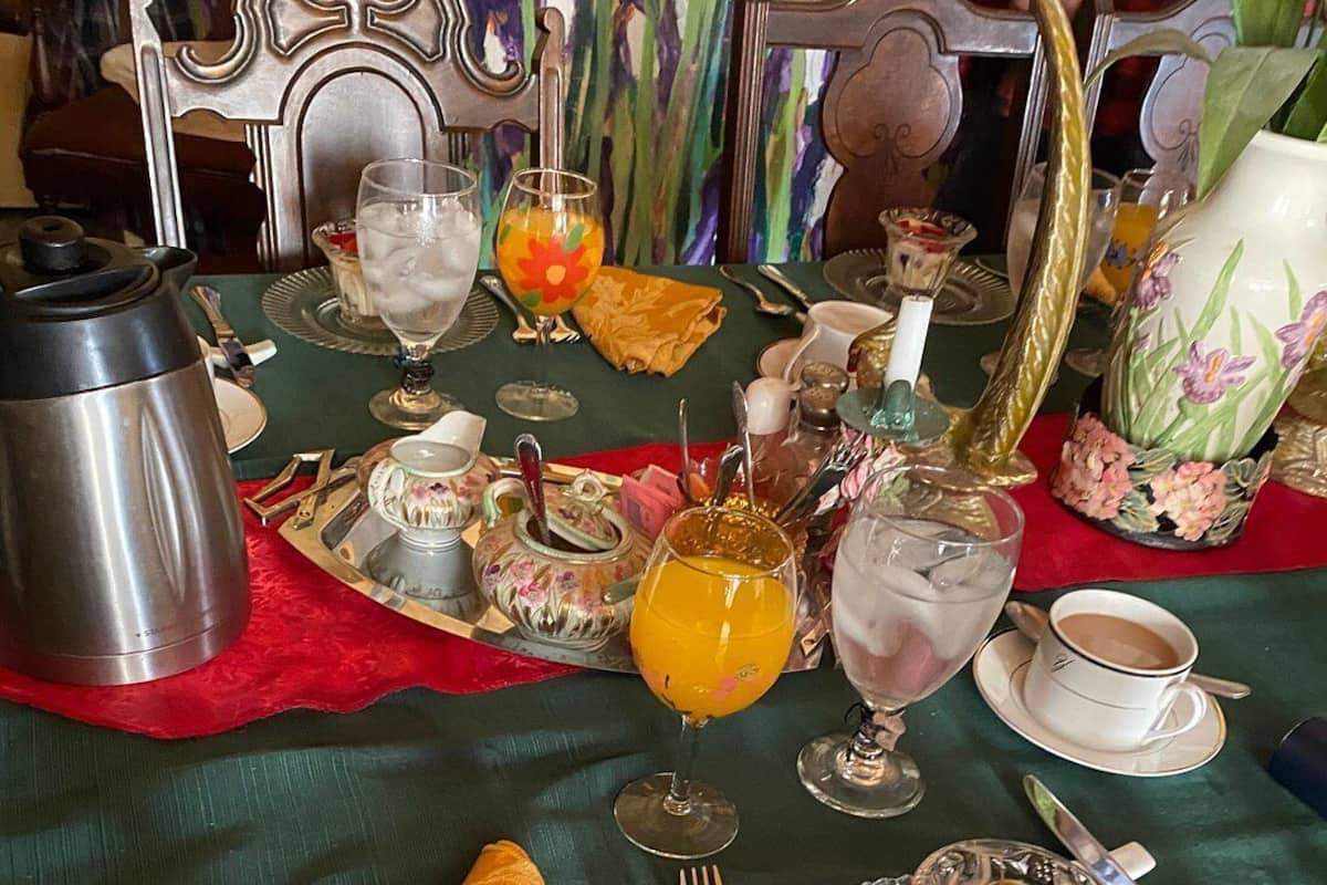 A dining table set with various dishes, glasses, and cutlery, indicating a meal setting.