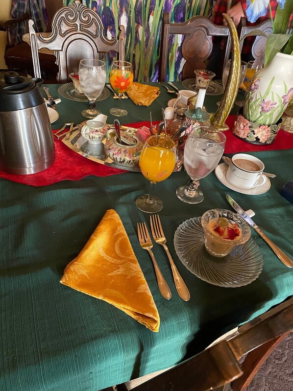 A dining table set with various dishes, glasses, and cutlery, indicating a meal setting.