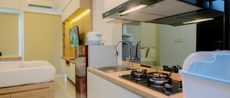 A compact kitchen with a gas stove, sink, and modern appliances.