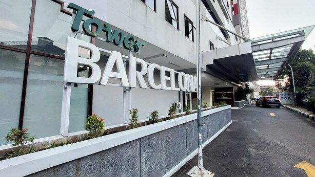 A building with a sign that reads "Tower Barcelona." - Good And Restful Studio (No Kitchen) At Sentraland Medan Apartment (Medan)