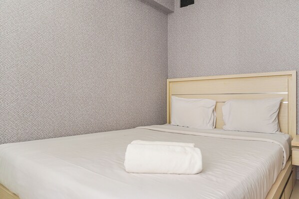 Restful retreat with a neatly made bed and a clean, simple design.