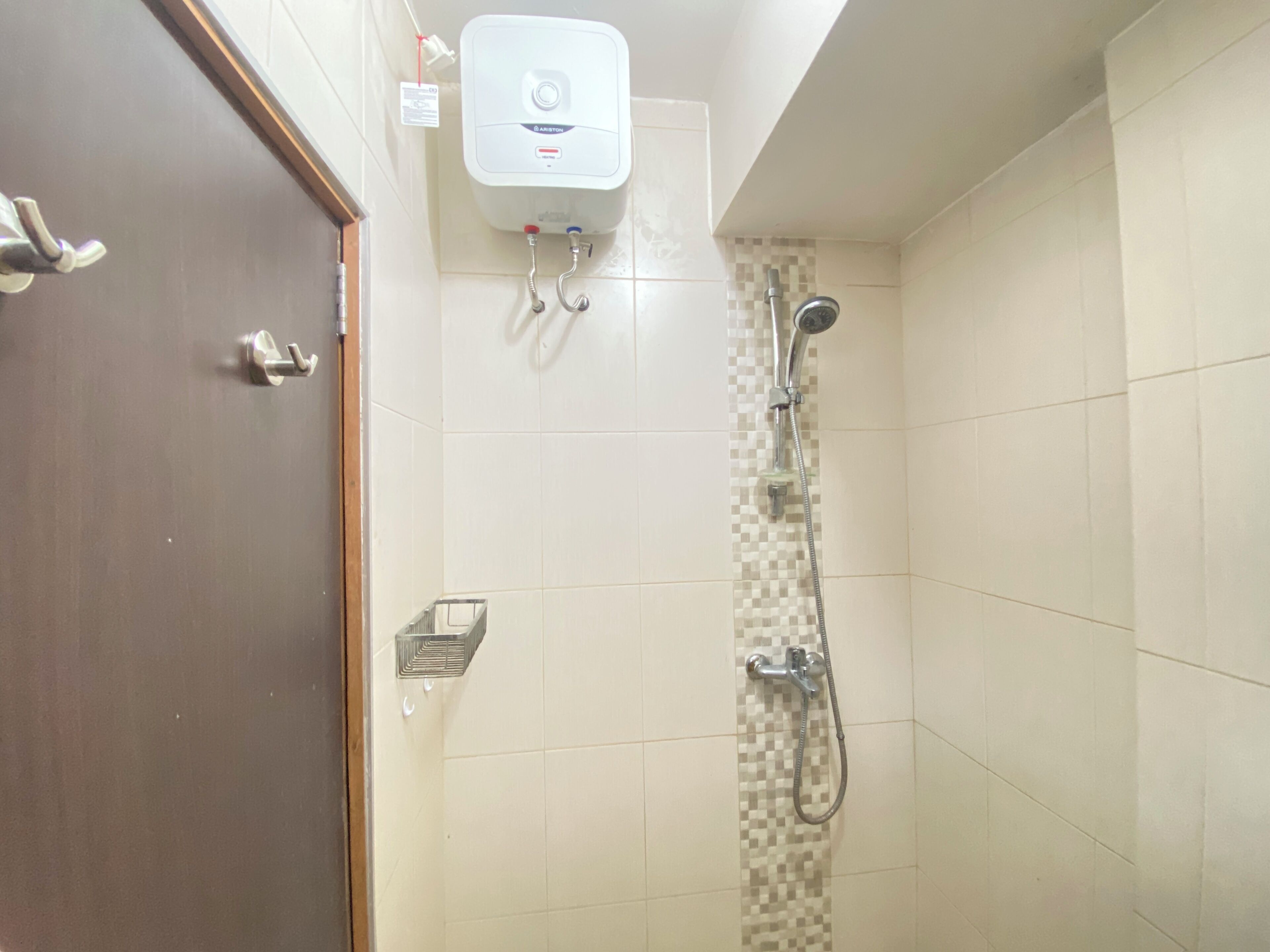 A bathroom with a shower, a toilet, and a sink.