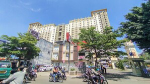 A multi-story building with a prominent "GATEWAY" sign, surrounded by trees and parked motorcycles. - Best Deal And Comfy 1Br Apartment Gateway Ahmad Yani Cicadas (Bandung)