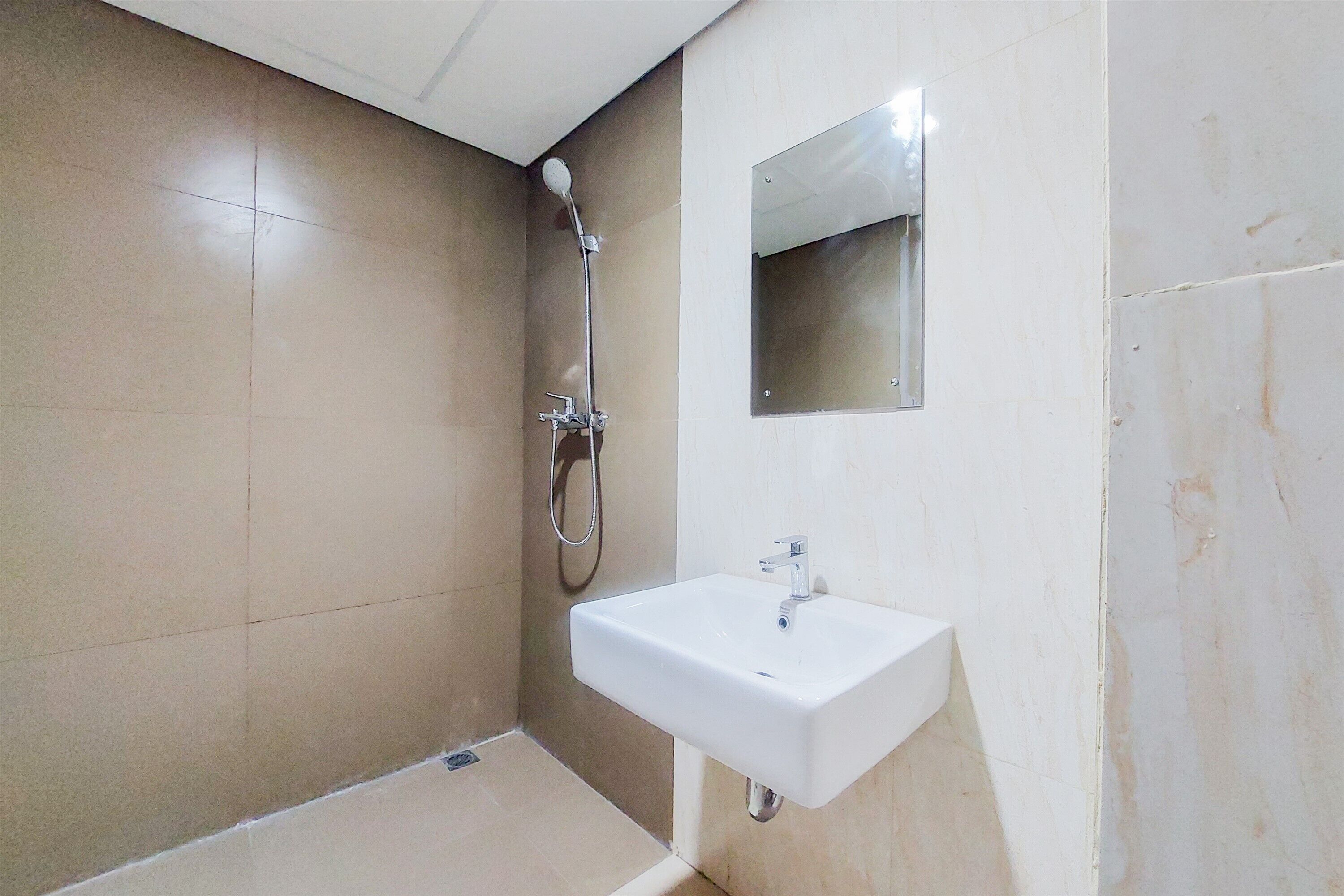 A bathroom with a shower, a sink, and a mirror.