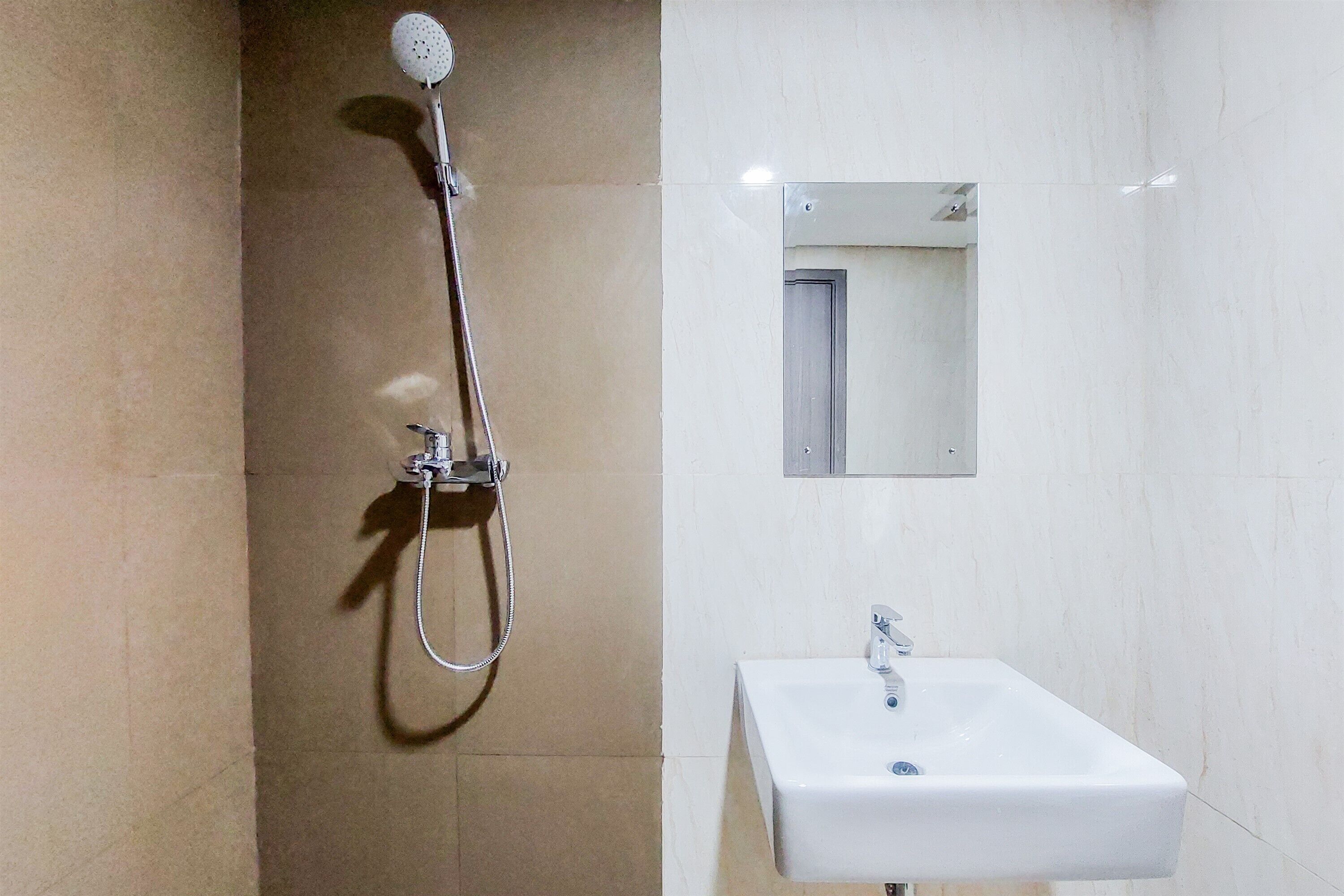 A bathroom with a shower, a sink, and a mirror.