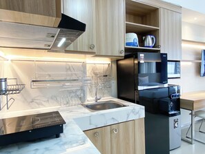 Studio | Private kitchen | Fridge, stovetop - Cozy Living Studio At Vasanta Innopark Apartment (Cikarang)