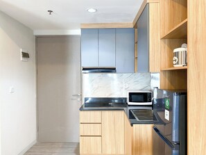 Studio | Private kitchen - Homey And Spacious Studio Vasanta Innopark Apartment (Cikarang)