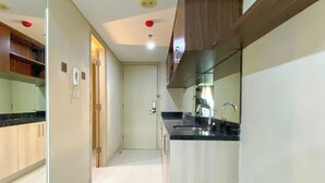 Studio | Private kitchen | Full-sized fridge, stovetop - Homey And Comfort Living Studio Apartment Warhol (W/R) Residences (Semarang)
