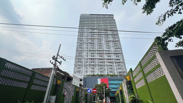 A modern building with a prominent 'melati' sign, surrounded by greenery and a paved walkway. - Comfy 2Br At Taman Melati Surabaya Apartment (Surabaya)