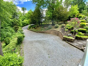 A gravel path winding through a lush garden with various plants and a brick wall. - -Hot Tub- @ Retreat near Gettysburg & Liberty Mtn Resort (Fairfield)