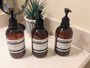 Three bottles of body wash, shampoo, and conditioner on a white surface. - -Hot Tub- @ Retreat near Gettysburg & Liberty Mtn Resort (Fairfield)