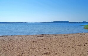 A sandy beach with calm water and a distant shoreline. - 1 bedroom amazing home in Silz (Silz)
