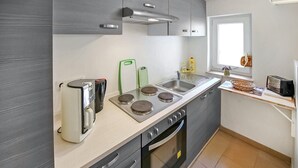 Una cucina moderna con forno, piano cottura e lavello integrati.
