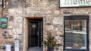A stone building with a black door and a large window. - River Merchant Inn Heintzman Music Suite (Stratford)