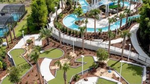 A golf course with multiple holes, a central water feature, and surrounding landscaping. - Fun 5BD/5.5BA Home w/Game Room, Pool & Free Resort Access near Disney (Davenport)