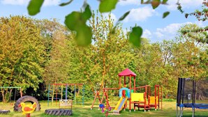 A playground with various play structures including a slide, swings, and a climbing frame. - 3 bedroom stunning home in Verchen (Verchen)