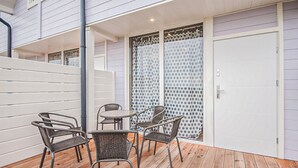 A patio with two wicker chairs and a small round table, a white door, and a polka dot curtain. - Gorgeous home in Sarbinowo with WiFi (Sarbinowo)