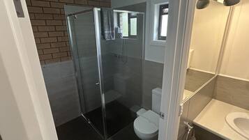 Shower, hydromassage showerhead, hair dryer, towels