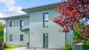 A modern two-story building with a flat roof, large windows, and a small front garden. - Ferienwohnung Karlshagen (Karlshagen (Ostseebad))