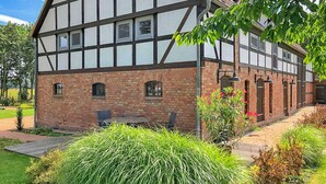 A traditional half-timbered building with a brick facade and multiple windows.