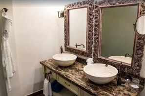 A bathroom with two large, ornate mirrors, a marble countertop, and a single sink. - 2BDFinisteria Resort Pool & Ocean Views (Cabo San Lucas)