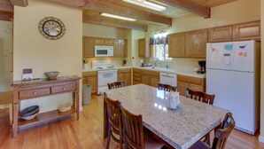A kitchen with wooden cabinets, a granite countertop, and a built-in oven. - Sierra Breeze - Your Yosemite Adventure Base Camp In Pine Mountain Lake (Groveland)