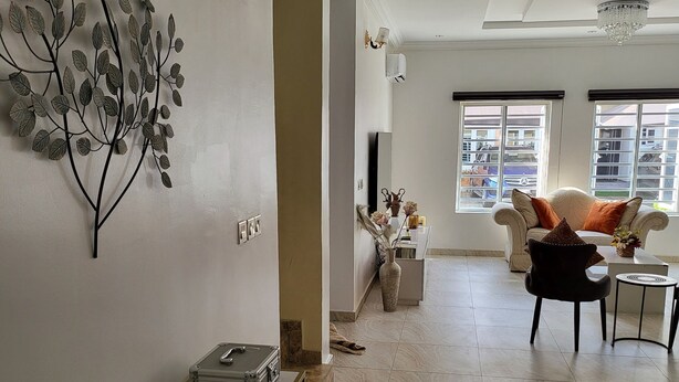 A modern living room with a sofa, a coffee table, and a decorative wall piece. - Dvyne Lux-Home-
Stylish, classy, secured duplex with elegant decor & 24hrs light (Ikeja)