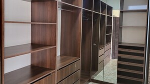 A walk-in closet with multiple shelves and drawers, a tiled floor, and a ceiling light. - Dvyne Lux-Home-
Stylish, classy, secured duplex with elegant decor & 24hrs light (Ikeja)