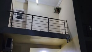 A multi-level building with a balcony, potted plants, and a door. - Dvyne Lux-Home-
Stylish, classy, secured duplex with elegant decor & 24hrs light (Ikeja)